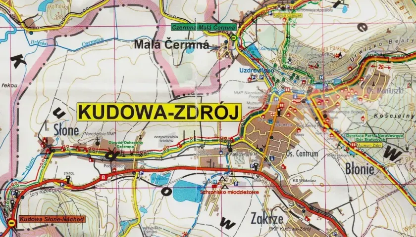 Mapa turystyczna z zaznaczonymi szlakami i miejscowościami, w tym Kudowa-Zdrój. Widoczne góry i doliny.