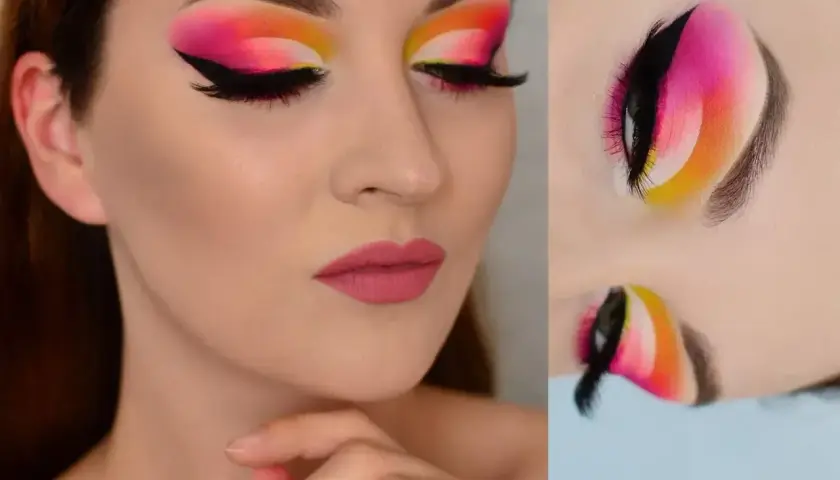Wyrazisty makijaż oczu w stylu cut crease z neonowym gradientem od żółci, przez róż, po fiolet. Czarne kreski i długie rzęsy podkreślają spojrzenie.