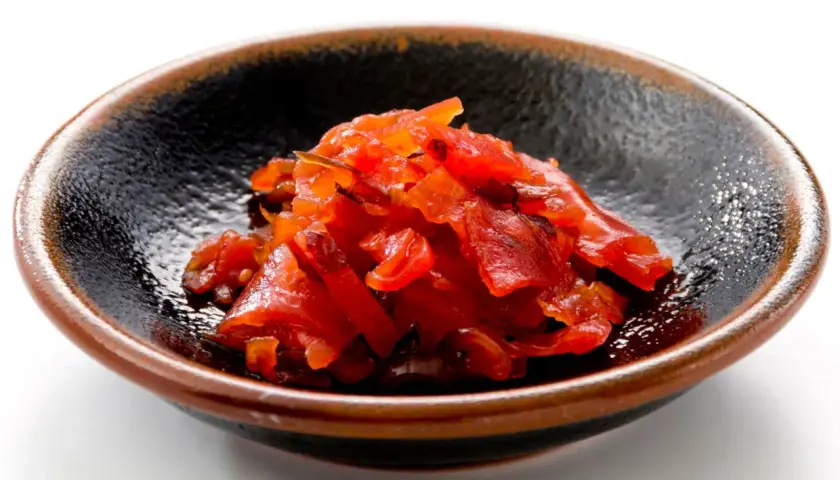 A small bowl of bright red fukujinzuke, a relish often served with Japanese curry. This image could be part of a fukujinzuke recipe.