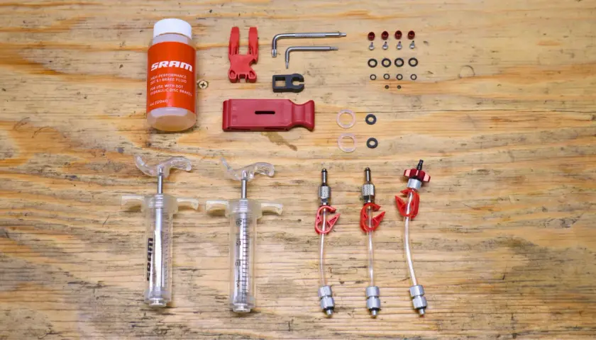 SRAM brake flush and bleed kit with syringes, fluid, and tools. Essential for maintaining hydraulic disc brakes.