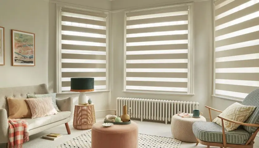 Modern living room with striped roller blinds, offering a stylish way to choose best window coverings.