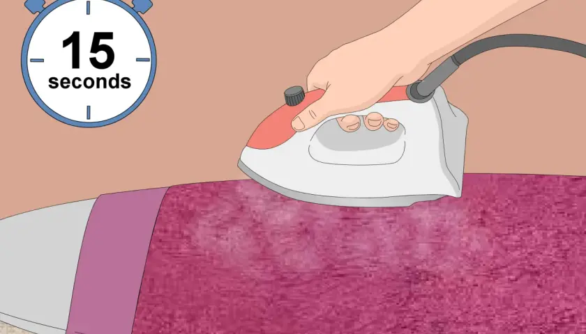 Ironing pink polyester velvet with steam for 15 seconds.