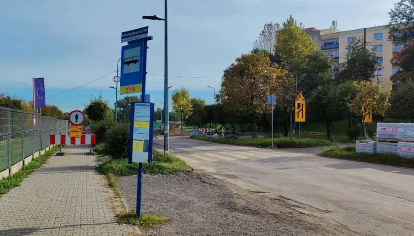 Przystanek autobusowy ZTM przy dworcu PKP w Grabownie Wielkim, z widocznym znakiem drogowym i pasami.