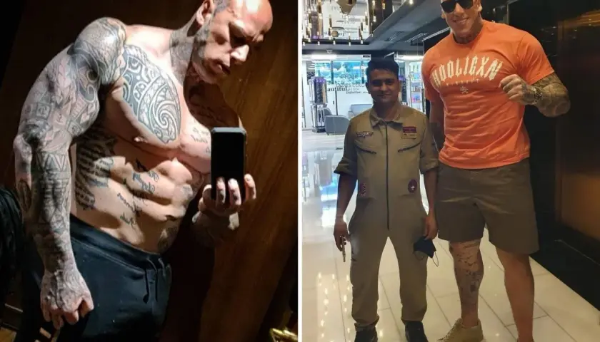 Martyn Ford, imposant comme Shao Kahn, pose avec un homme en uniforme. Le colosse est couvert de tatouages.