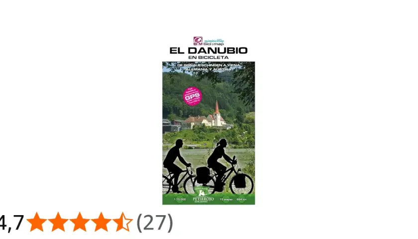 Ruta en bici por el Danubio, de Alemania a Austria. Paisaje fluvial con ciclistas y un pueblo con iglesia.