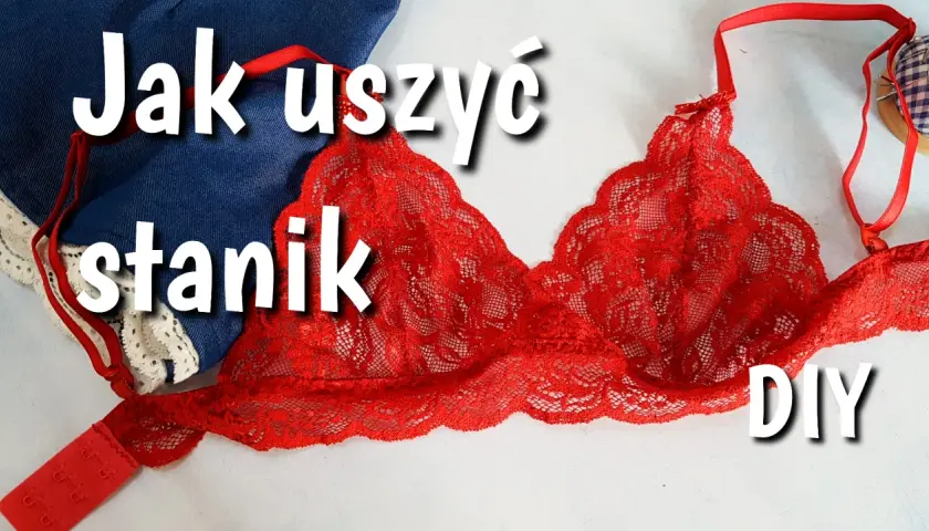 Jak uszyć bralet? Czerwony, koronkowy stanik DIY leży obok dżinsu i białej koronki.