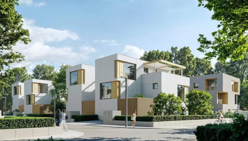 Nowa Królikarnia: nowoczesne domy z drewnianymi akcentami, otoczone zielenią. Ludzie spacerują, rowerzystka przemierza ulicę.