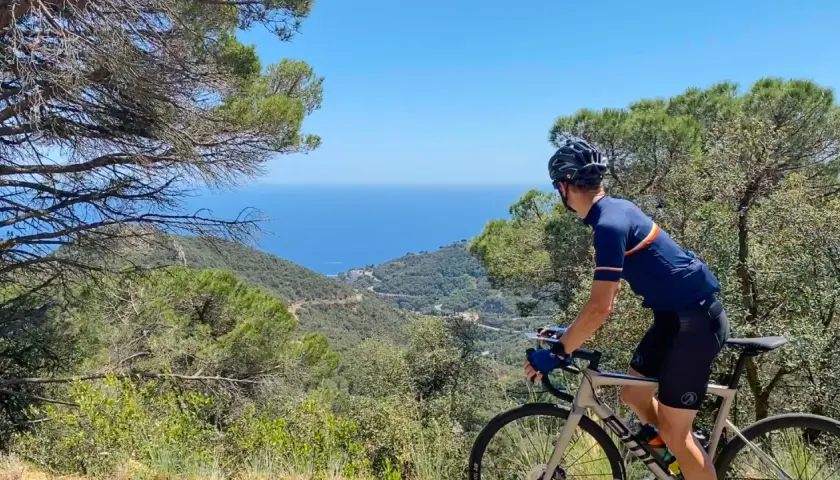 Cyclist enjoys a scenic ride, taking in breathtaking coastal views. This could be one of the best cycling routes in Europe.