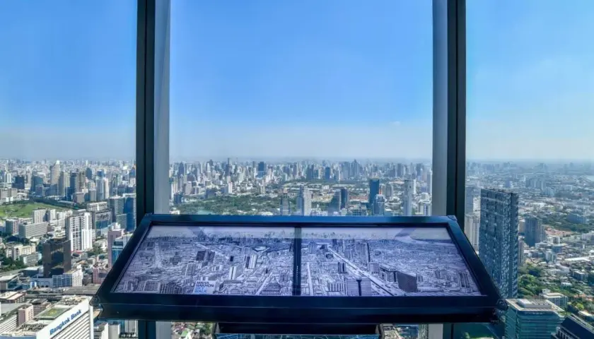 Blick vom Mahanakhon Skywalk auf Bangkok. Eine Karte der Stadt liegt auf einem Tisch.