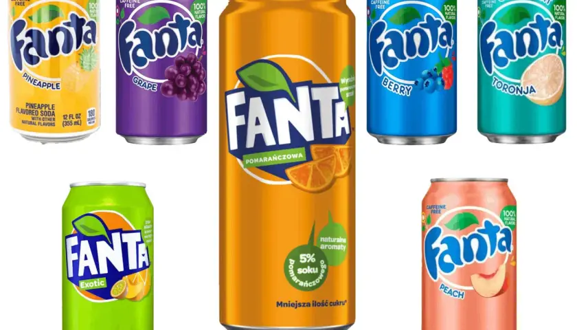 Puszki napojów Fanta o różnych smakach: pomarańczowa, winogronowa, egzotyczna, brzoskwiniowa, jagodowa i grejpfrutowa.