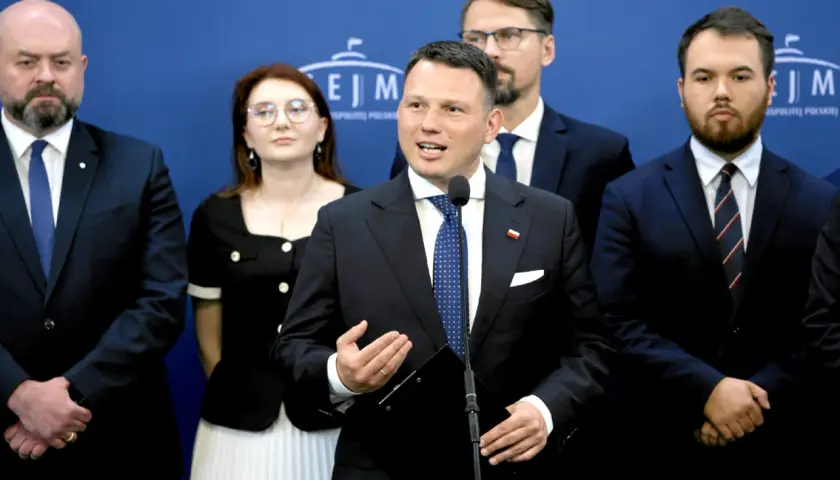 Konfederacja i europejscy eurosceptycy: prawdziwa historia współpracy. Politycy w garniturach na tle niebieskiej ściany.