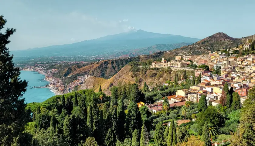 A stunning view of Taormina, Sicily, with Mount Etna in the distance. Perfect for a 14-day Sicily itinerary.