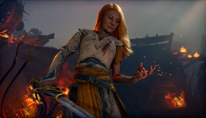 La guerriera bionda, con un'armatura ferita, evoca scintille in un paesaggio in fiamme. Un nuovo God of War è in arrivo.