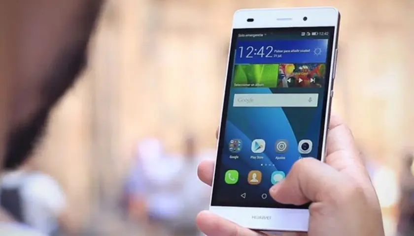Dłoń trzyma smartfon Huawei P8 Lite, pokazując ekran z ikonami. Dowiedz się, jak zaktualizować Androida w Huawei P8 Lite.