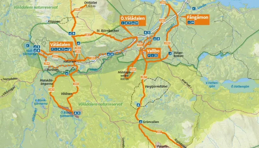 Karta över Vålådalen med markerade leder för vålådalen vandring. Visar Vålådalens naturreservat, fjälltoppar, sjöar och byar som Vallbo och Fångåmon.