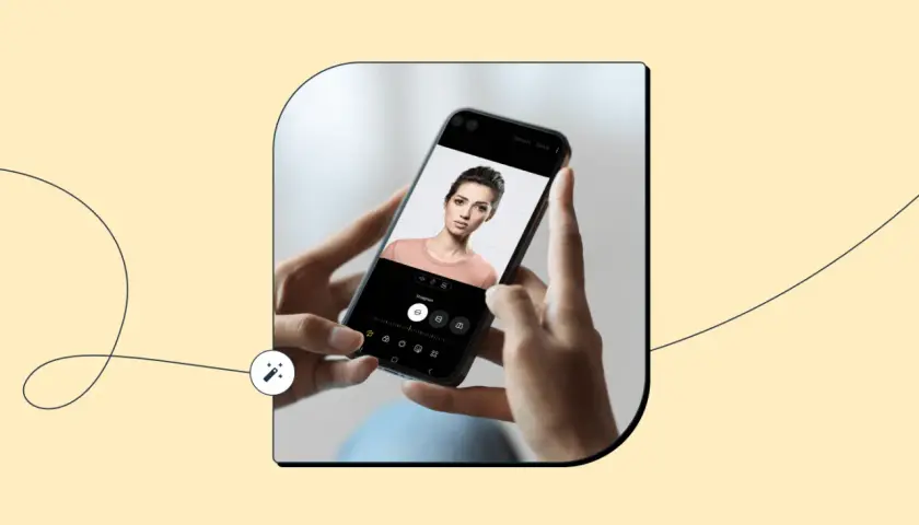 Dłonie trzymają smartfon z portretem kobiety. Na ekranie widać narzędzia edycyjne, sugerujące aplikacje dla fotografów.