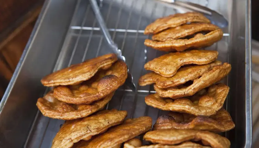 Golden brown, freshly fried Japanese rice crackers cooling on a rack. This image captures the essence of a delicious Japanese rice crackers recipe.