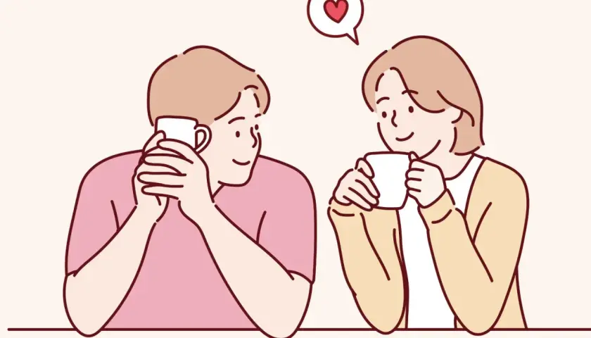 Coppia che sorseggia bevande calde, con un cuore che fluttua sopra di loro. Sembra che stiano iniziando a idealizzare una persona.