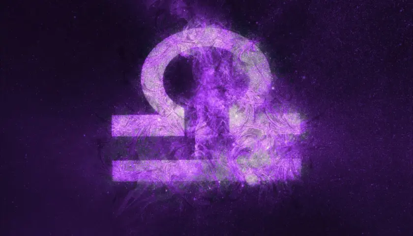 Symbol Wagi, 17 września znak zodiaku, w fioletowej mgławicy kosmicznej.