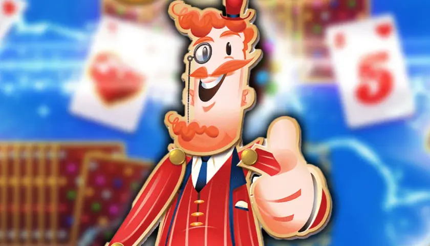 Postać z gry Candy Crush Saga z kciukiem w górę, w tle karty do gry.