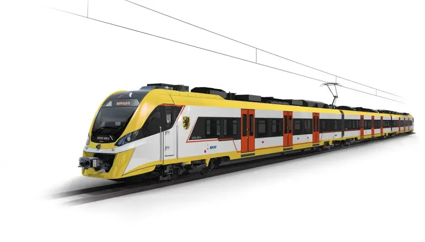 Nowoczesny, żółto-biały pociąg elektryczny Impuls II, jeden z wielu rodzajów pociągów, jedzie po torach pod siecią trakcyjną.