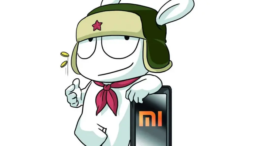 Mi Bunny w czapce z gwiazdą i szaliku, z kciukiem w górę, obok telefonu Redmi z logo MI. Może to symbolizować szybkie uruchamianie (fastboot) lub po prostu dumę z marki.