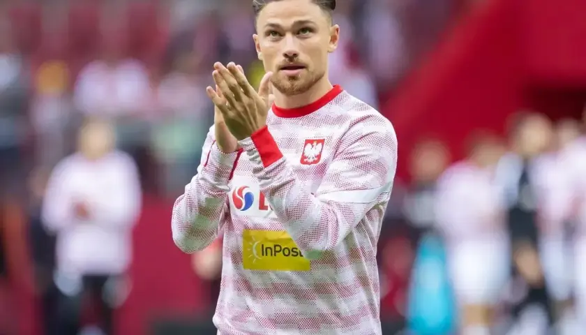Piłkarz Matty Cash, dumny ze swojego polskiego pochodzenia, w biało-czerwonej koszulce reprezentacji Polski.