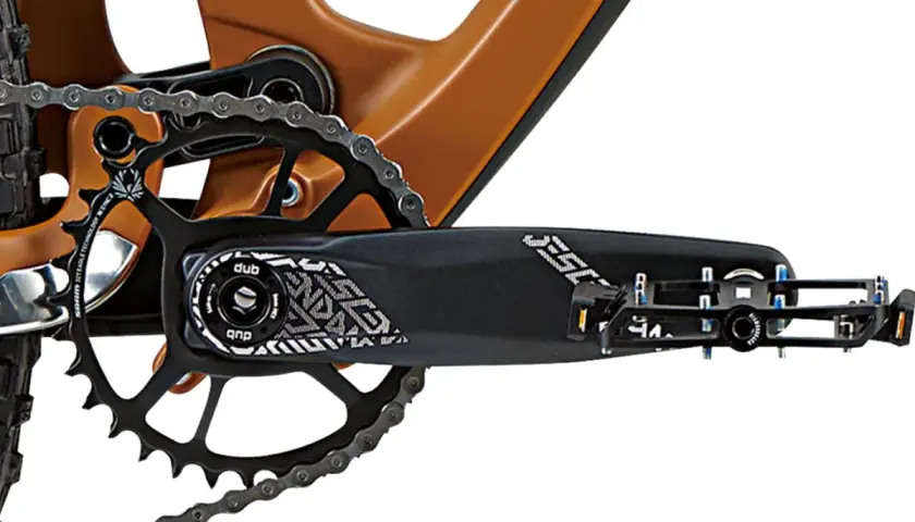 Close-up of a bike's crankset and chainring, showing the DUB bottom bracket and pedal.