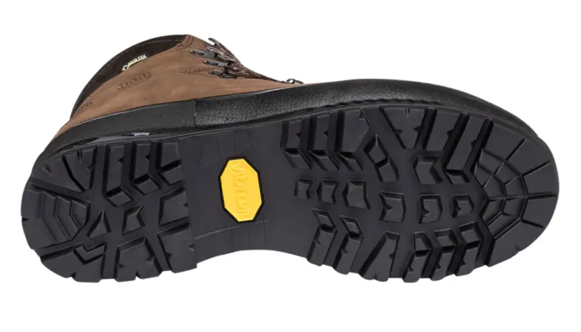 A brown hiking boot with a rugged, deep-lugged Vibram sole, showcasing various types of boot soles for optimal traction.