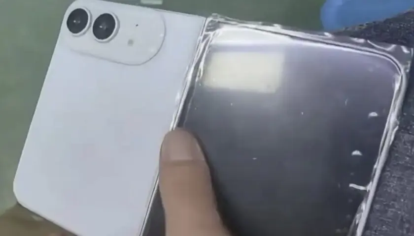Biały telefon z dwoma aparatami, przypominający iPhone flip, jest rozkładany.