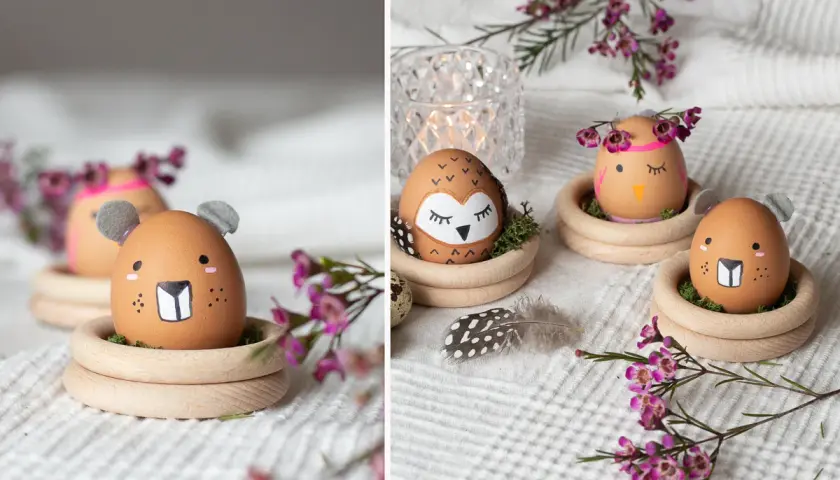 Kreative Oster Eier Malen: Ein Eichhörnchen-Ei mit Ohren, ein Eulen-Ei und ein Küken-Ei sitzen in Holzringen.