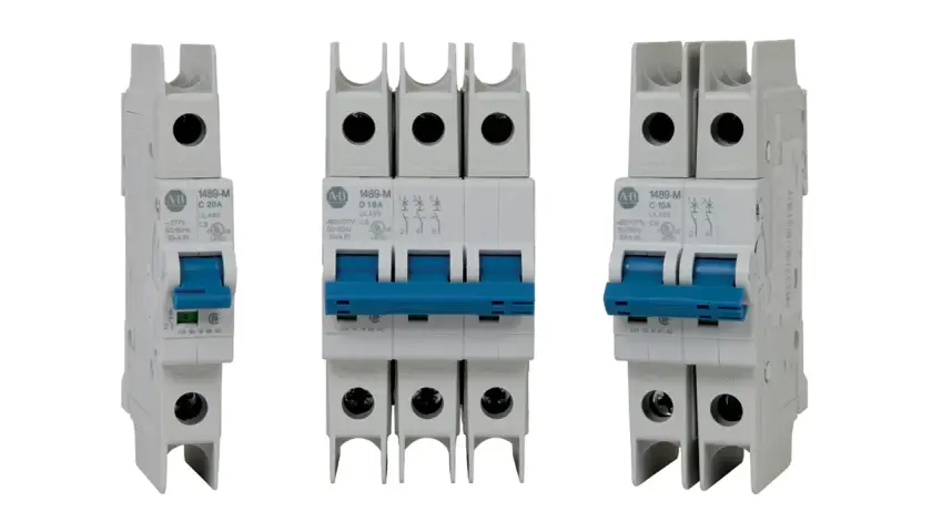 Three white circuit breakers with blue toggles. The middle one is a triple-pole slow blow circuit breaker, while the outer two are single-pole.