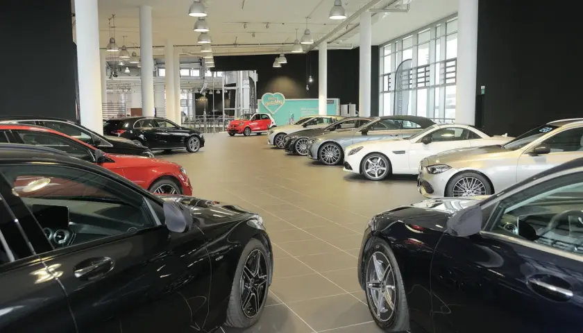 Interno concessionario con diverse auto in esposizione, pronte per una permuta auto concessionario.