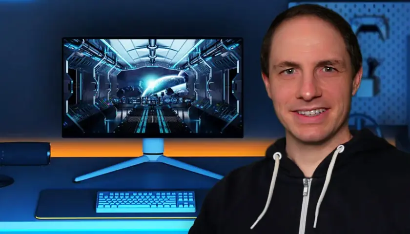 Mann vor einem Gaming-Setup mit Weltraum-Hintergrund auf dem Monitor. Die Frage, wie viel FPS das Auge sehen kann, wird hier visuell thematisiert.