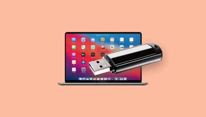 Pendrive na tle ekranu MacBook Pro. Dowiedz się, jak odzyskać pliki z pendrive, gdy dane znikną.