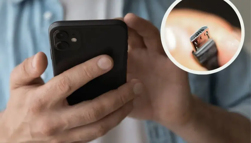 Dłonie trzymają czarny smartfon. W okręgu zbliżenie na wtyczkę USB-C, która pokazuje, jak ładować nowy telefon.