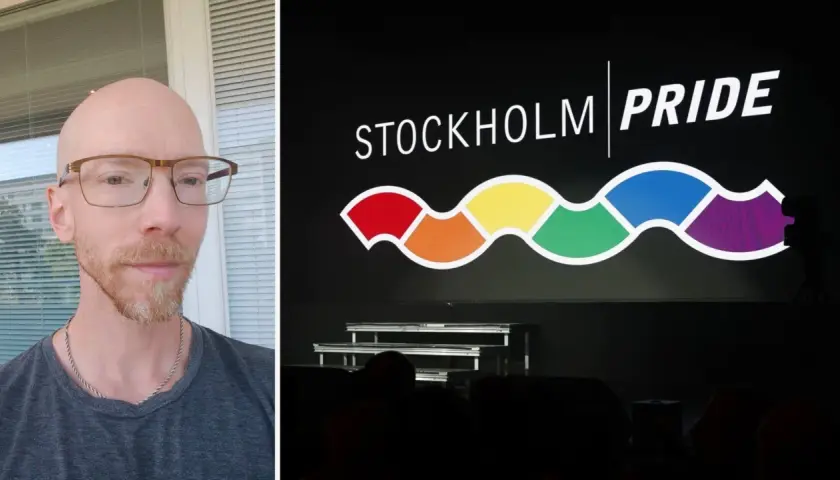 Man med glasögon och skägg framför en skärm med texten STOCKHOLM PRIDE och en regnbågsfärgad våg.
