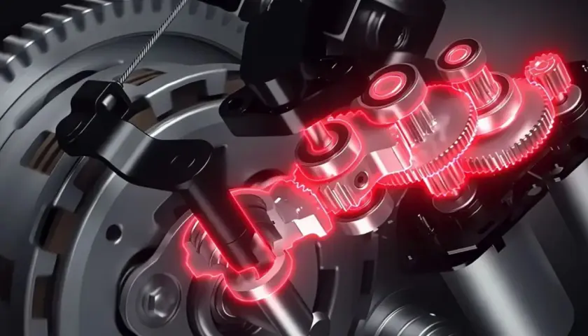 Mecanismo interno de un e clutch Honda, con engranajes y componentes metálicos iluminados en rojo.