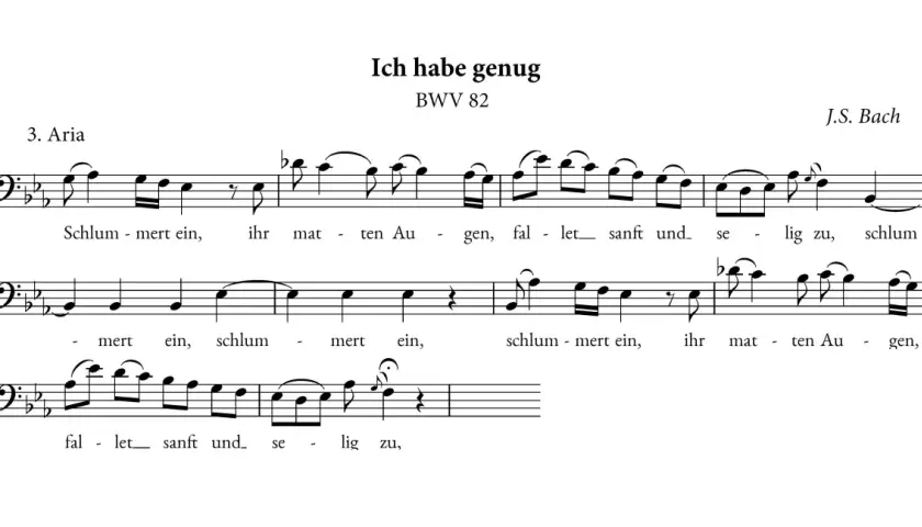 Fragment partytury z arii "Ich habe genug" BWV 82 J.S. Bacha. Widać tekst "Schlum-mert ein, ihr mat-ten Au-gen, fal-let sanft und se-lig zu". Tercet nut.