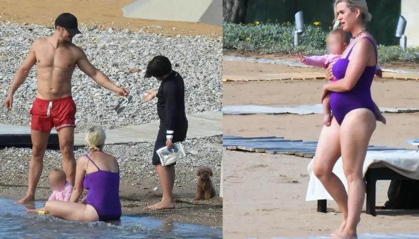 Katy Perry z dziećmi na plaży. Wokalistka w fioletowym stroju kąpielowym trzyma na rękach córkę.