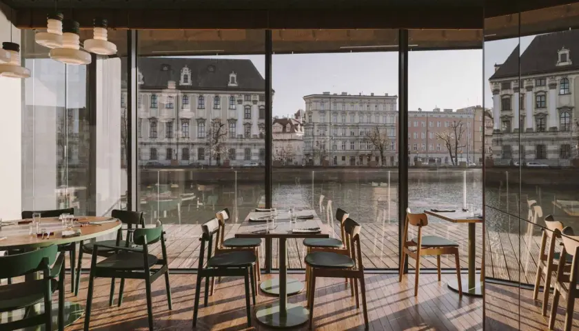 Nowoczesne wnętrze z widokiem na Odrę i zabytkową architekturę. Idealne miejsce na romantyczną kolację w jednej z klimatycznych restauracji Wrocławia.