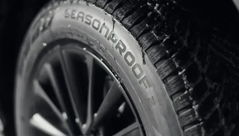 Opona Nokian Seasonproof z kroplami wody. Nokian to fińska firma, znana z produkcji opon zimowych i całorocznych.