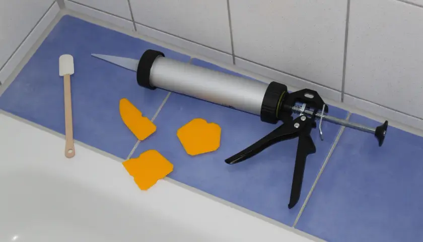 Pistolet do silikonu, szpachelki i drewniana łopatka gotowe do wymiany silikonu w kabinie prysznicowej.