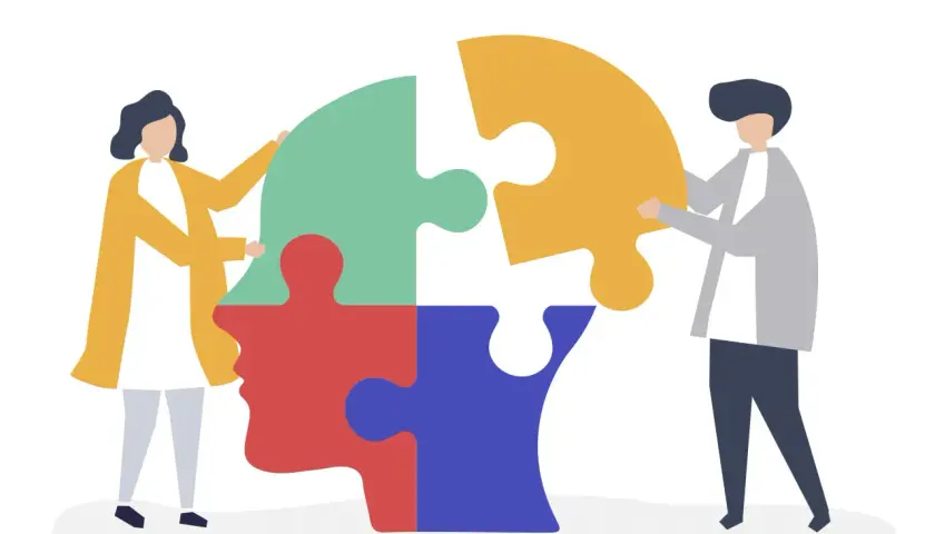 Due persone compongono un puzzle a forma di testa, simbolo della psicoterapia sistemico relazionale.