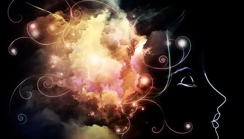 Kopfprofil mit wirbelnden, farbigen Wolken, die Gedanken und Ideen symbolisieren. Ein Gefühl von Brain Fog Deutsch, wenn die Gedanken unklar sind.
