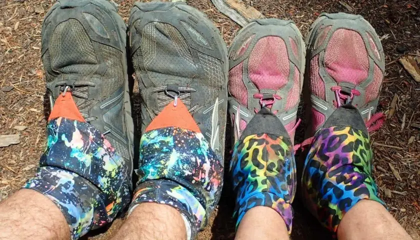 Four pairs of hiking shoes with colorful gaiters. The question "do boots run bigger than shoes" is irrelevant here.