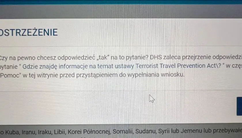 Okno dialogowe z ostrzeżeniem "OSTRZEŻENIE" dotyczące pytania o podróże do USA.