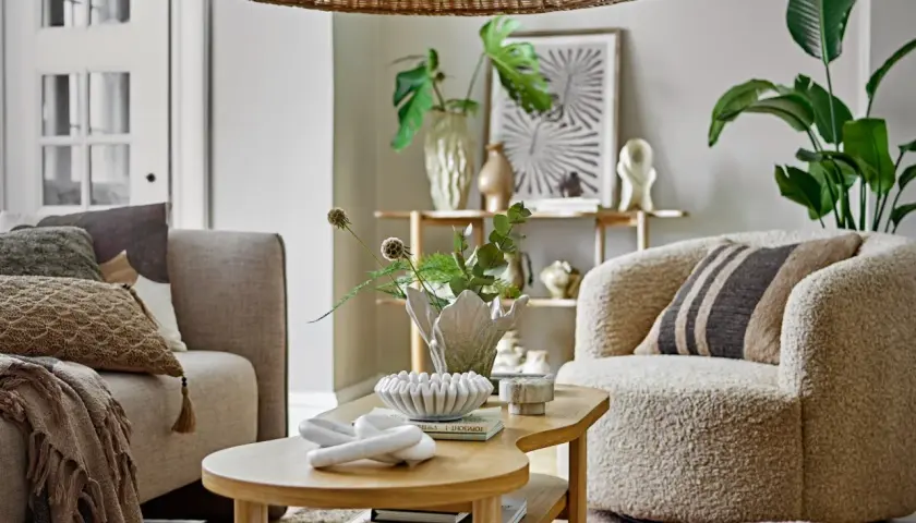 Przytulny salon w stylu skandynawskie boho. Miękkie tkaniny, naturalne materiały i rośliny tworzą relaksującą atmosferę.
