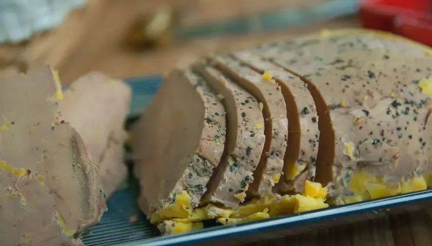 Tranche de foie gras assaisonnée, prête à être dégustée avec un vin blanc de Bourgogne.