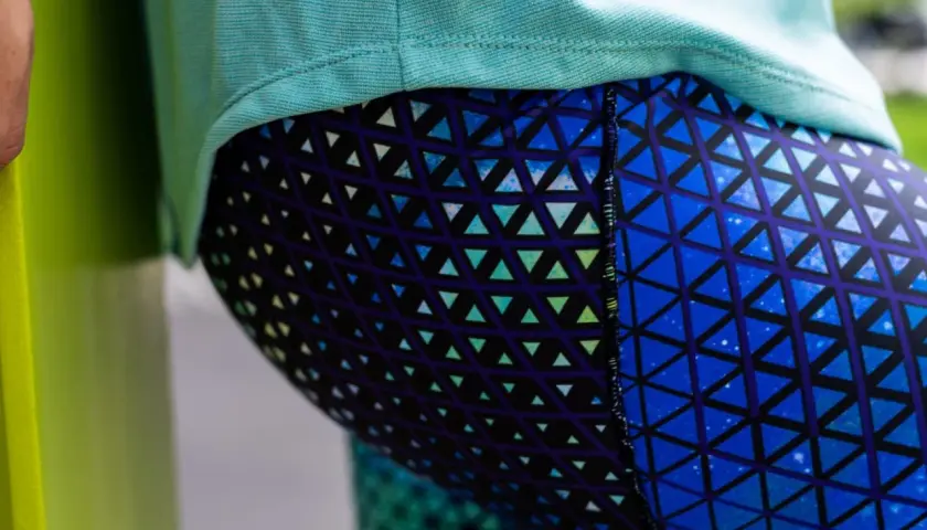 Close-up of a person wearing blue leggings with a geometric triangle pattern. This image could be part of a tutorial on how to sew leggings.